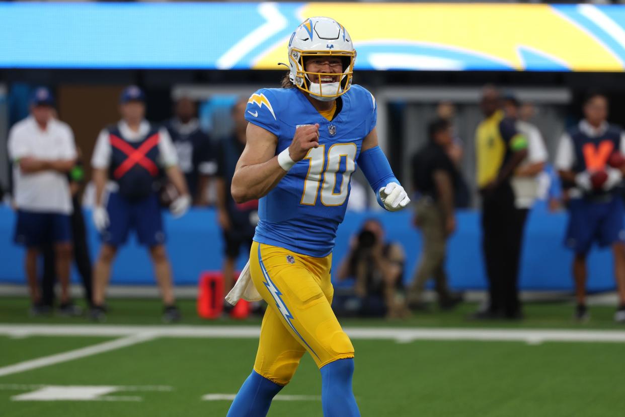 Los Angeles Chargers quarterback Justin Herbert (10) reacts after throwing a touchdown pass during the first quarter against the Dallas Cowboys at SoFi Stadium.