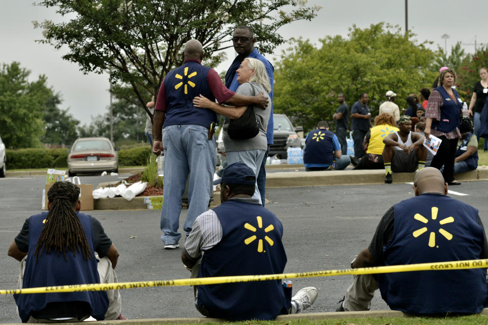 Walmart employees gather in a nearby parking lot after a shooting at the store, Tuesday, July 30, 2019, in Southaven, Miss. A gunman fatally shot two people and wounded a police officer before he was shot and arrested Tuesday at the Walmart in northern Mississippi, authorities said. (AP Photo/Brandon Dill)