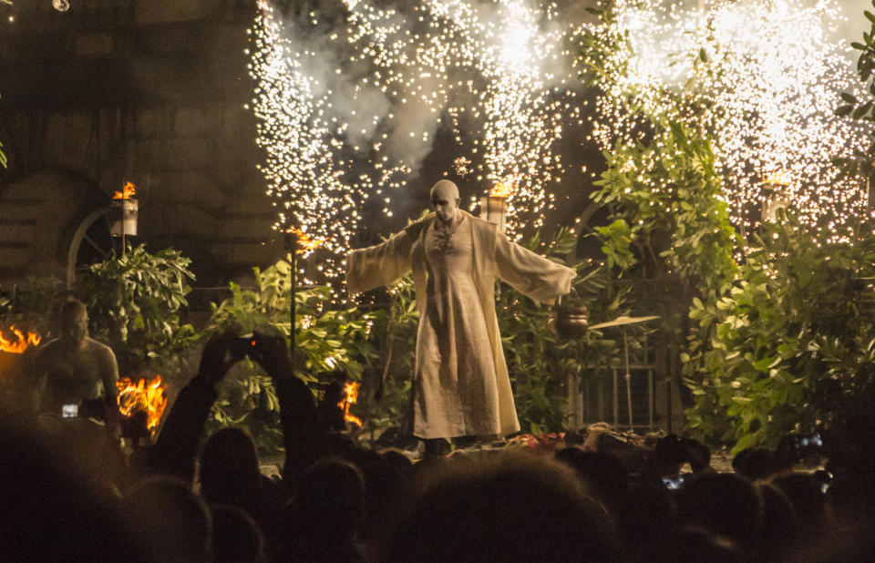 Edinburgh, UK - October 31, 2013: After a torchlit procession through Edinburgh to celebrate the pagan festival of Samhuinn, or Samhain, the Beltane Fire Society perform the triumph of winter over summer and celebrate the changing of the seasons before crowds of thousands in the street in front of St Giles Cathedral.