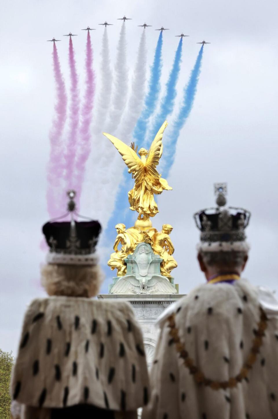 Britain's King Charles III and Queen Camilla watch the Red Arrows' aerobatics display from the balcony of Buckingham Palace.