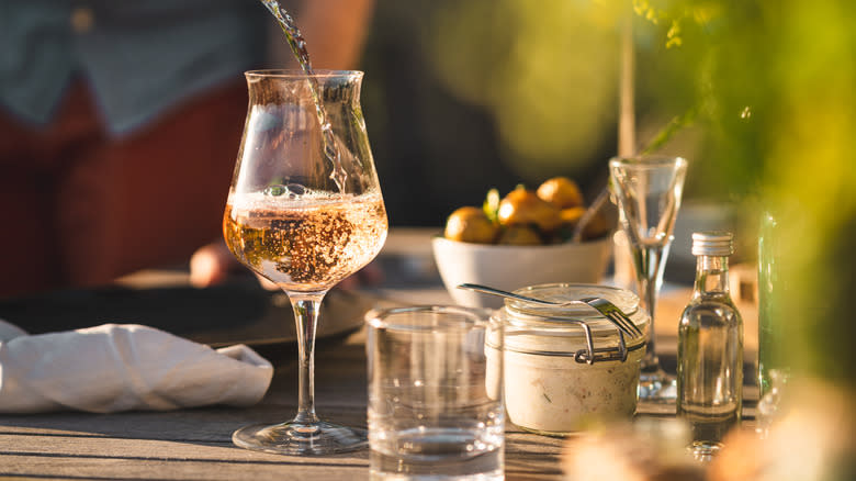 pouring glass of rose wine