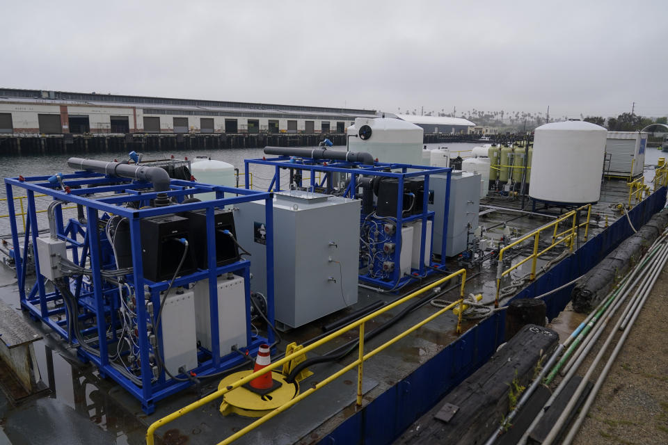 A demonstration site of a seawater-based carbon removal system is set up on a barge, Wednesday, April 12, 2023, in San Pedro, Calif. Equatic, a Los Angeles startup that is designing facilities to remove carbon dioxide from the ocean says it has struck an agreement with Boeing to provide the aerospace giant with a byproduct of the process to help it cut emissions from planes. (AP Photo/Ashley Landis, File)