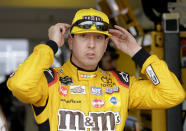 Kyle Busch adjusts his glasses during practice for the NASCAR Cup auto race at the Homestead-Miami Speedway, Friday, Nov. 16, 2018, in Homestead, Fla. (AP Photo/Terry Renna)