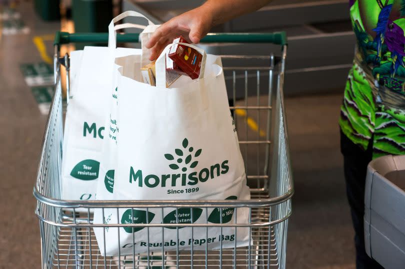 A customer places goods in to a paper bag at a Morrisons supermarket, operated by Wm Morrison Supermarkets Plc, in Saint Ives, U.K., on Monday, July 5, 2021. Apollo Global Management Inc. said Monday it's considering an offer for Morrison, heating up a takeover battle for the U.K. grocer. Photographer: Chris Ratcliffe/Bloomberg via Getty Images