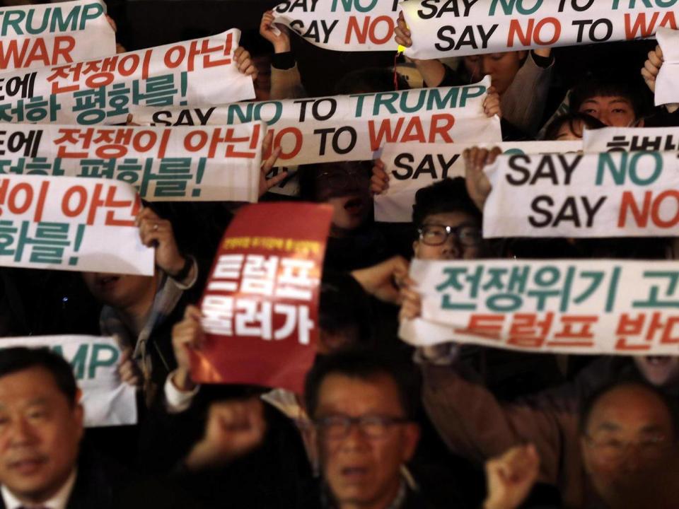 Protesters take part in an anti-Trump rally in front of the US Embassy in Seoul today (Getty)