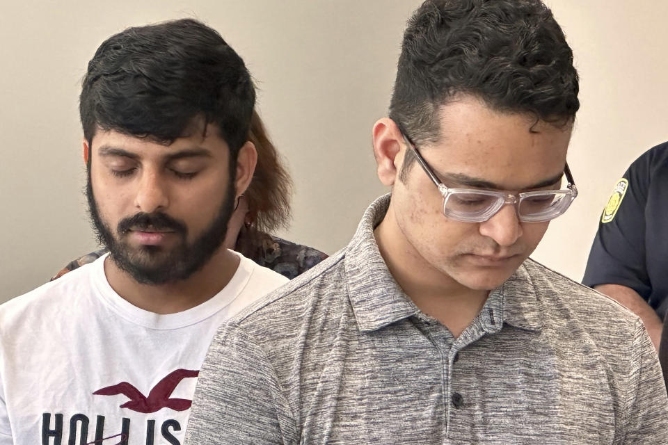 Eastern Michigan University students Akash Pathpi, left, and Gyan Dev Singh remember Aishwarya Thatikonda, a 2020 graduate, who was killed in the May 6 mall shooting in Dallas, during a ceremony at The Lakehouse on the EMU campus in Ypsilanti, Mich. on Wednesday, May, 10, 2023. (Samuel Dodge/Ann Arbor News via AP)