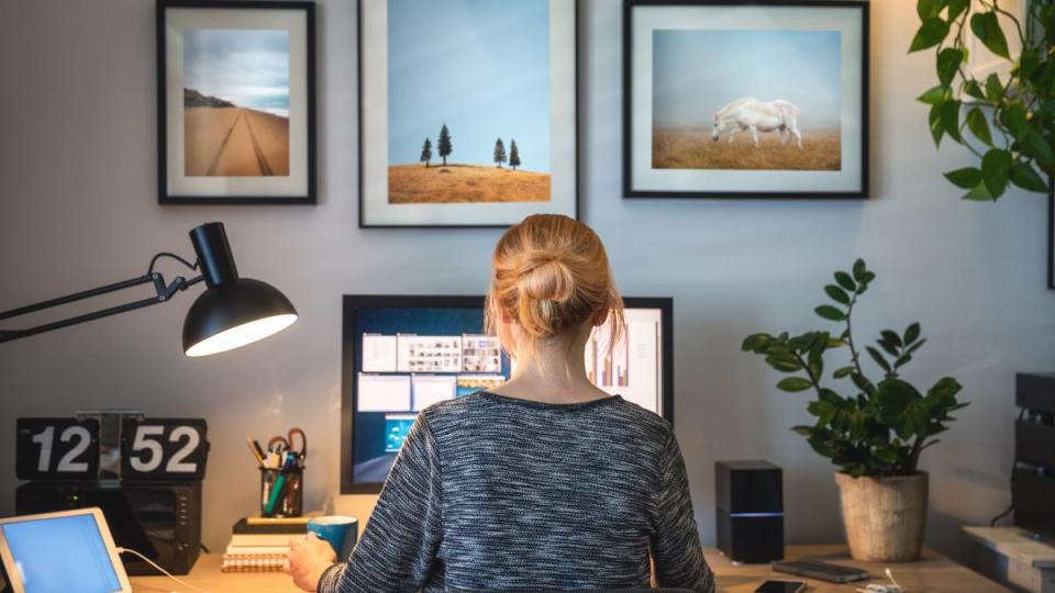 Work from home typing jobs: Woman working on computer in her home office during pandemic quarantine.