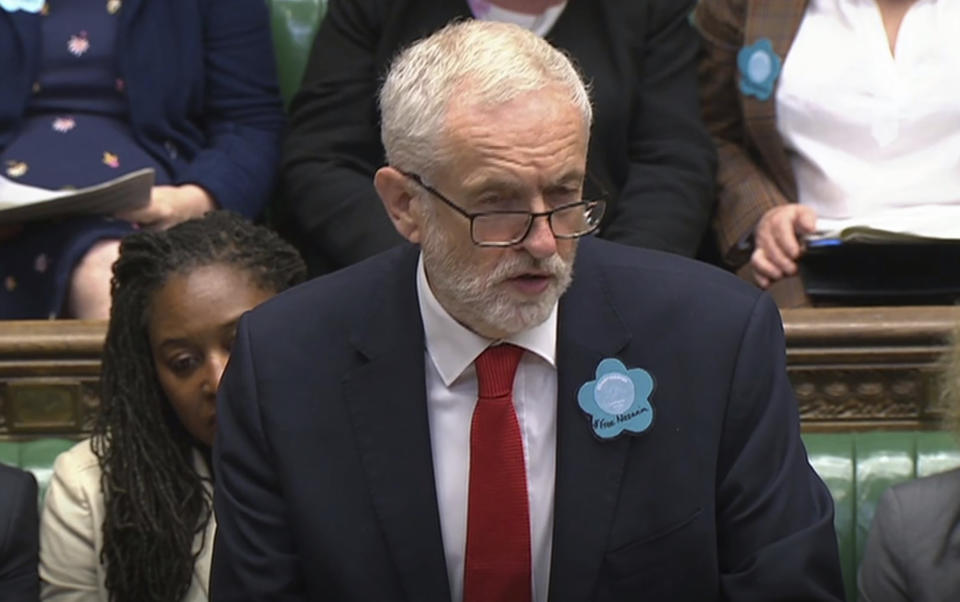 Britain's main opposition Labour Party leader Jeremy Corbyn wears a "Free Nazanin" badge as he speaks during Prime Minister's Questions session at the House of Commons in London, Wednesday June 26, 2019.  Nazanin Zaghari-Ratcliffe is a British-Iranian dual citizen who has been imprisoned in Iran for over three years. (House of Commons TV / PA via AP)