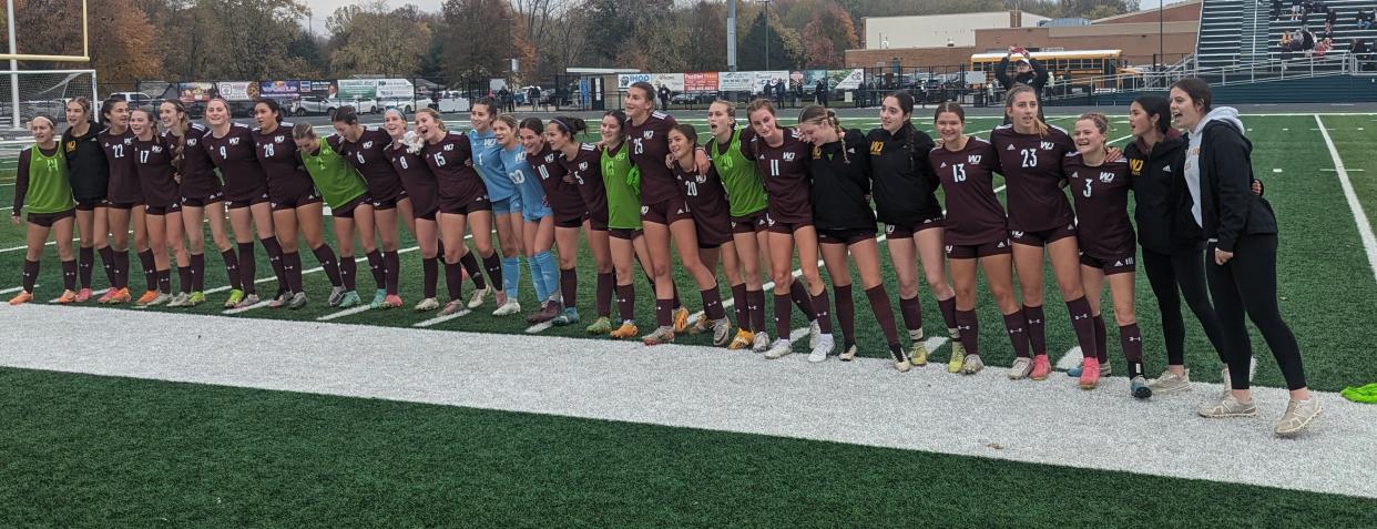 The Walsh Jesuit girls soccer team sings the alma mater with its fans after a 2-1 win over Magnificat.