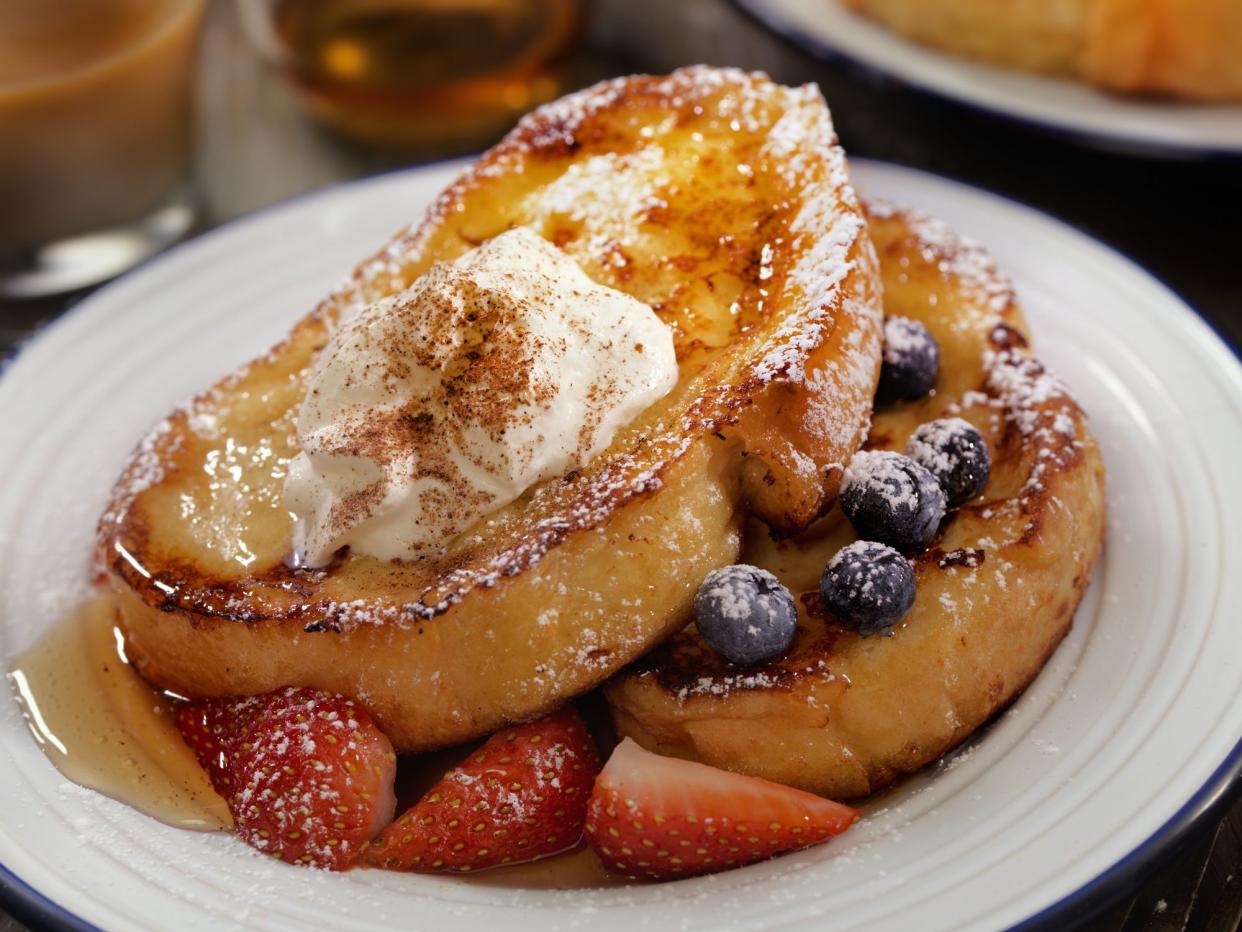 French Toast with Maple Syrup, Berries Whip Cream and Cinnamon