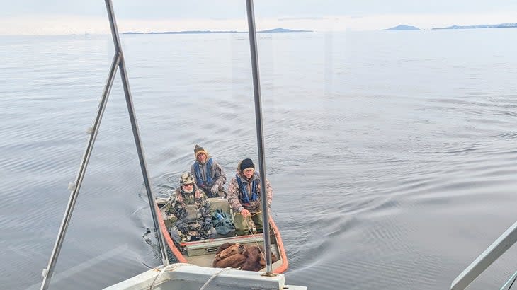 <span class="article__caption">Another hunter and his guides return to the boat after a successful hunt. </span> (Photo: Wes Siler)