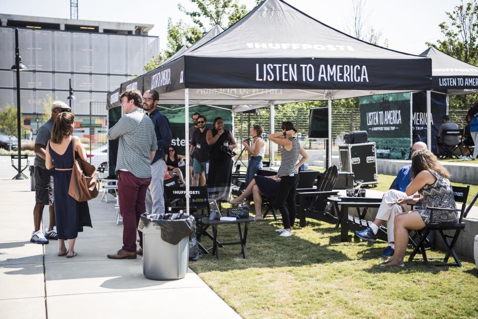 HuffPost employees talk with visitors to the Listen to America tents.