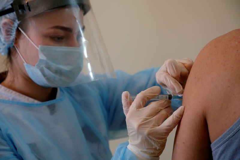 FILE PHOTO: A person receives an injection with Sputnik V (Gam-COVID-Vac) vaccine against the coronavirus disease (COVID-19) in Donskoye