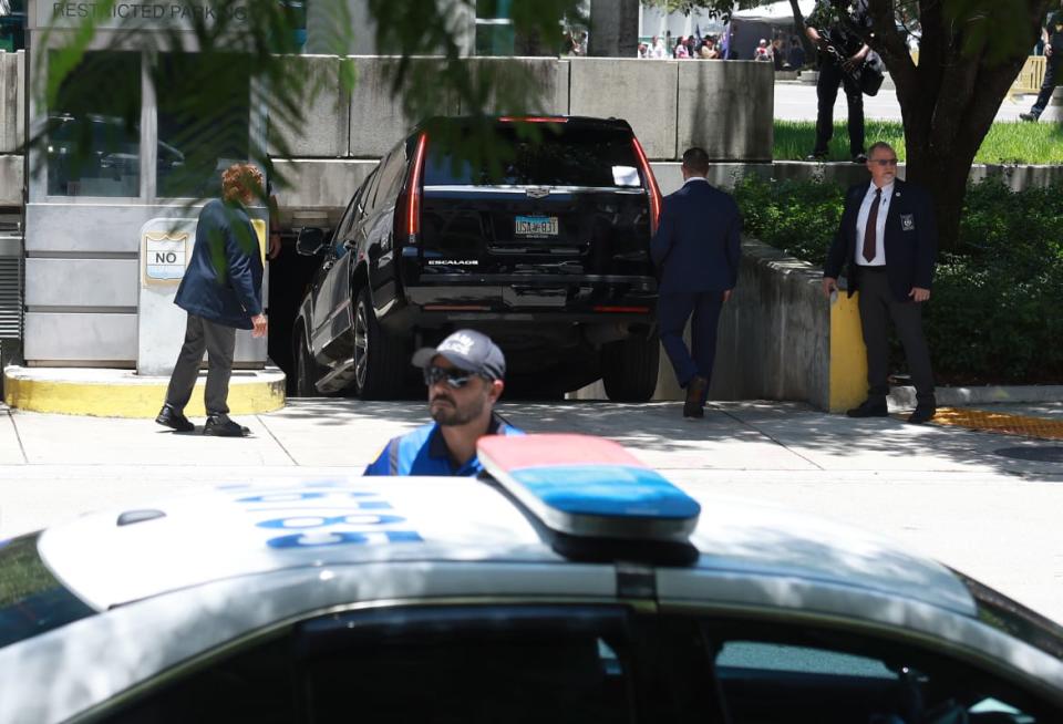 <div class="inline-image__caption"><p>The motorcade carrying former President Donald Trump arrives to the Wilkie D. Ferguson Jr. United States Federal Courthouse.</p></div> <div class="inline-image__credit">Joe Raedle/Getty</div>