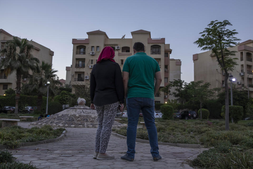 Noha, an Egyptian engineer, and her husband Ahmed, who were chosen to be among the U.S. government's roughly 50,000 visa lottery winners this year, pose for a photograph near their home in Cairo, Egypt, Tuesday, June 30, 2020. While visas for Noha and her children came in February, Ahmed's has not arrived and now they fear it may never come. President Donald Trump in June halted visas from being issued outside the United States through the end of the year. (AP Photo/Nariman El-Mofty)