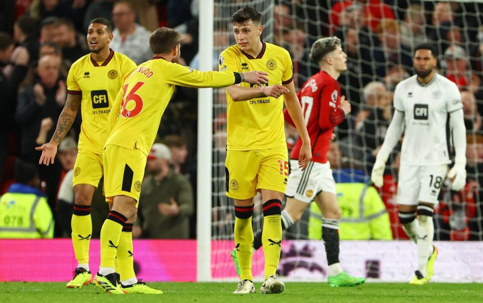 Old Trafford, Manchester, Britain - April 24, 2024 Sheffield United's Oliver Norwood and Anel Ahmedhodzic look dejected after Manchester United's Bruno Fernandes scores their third goal