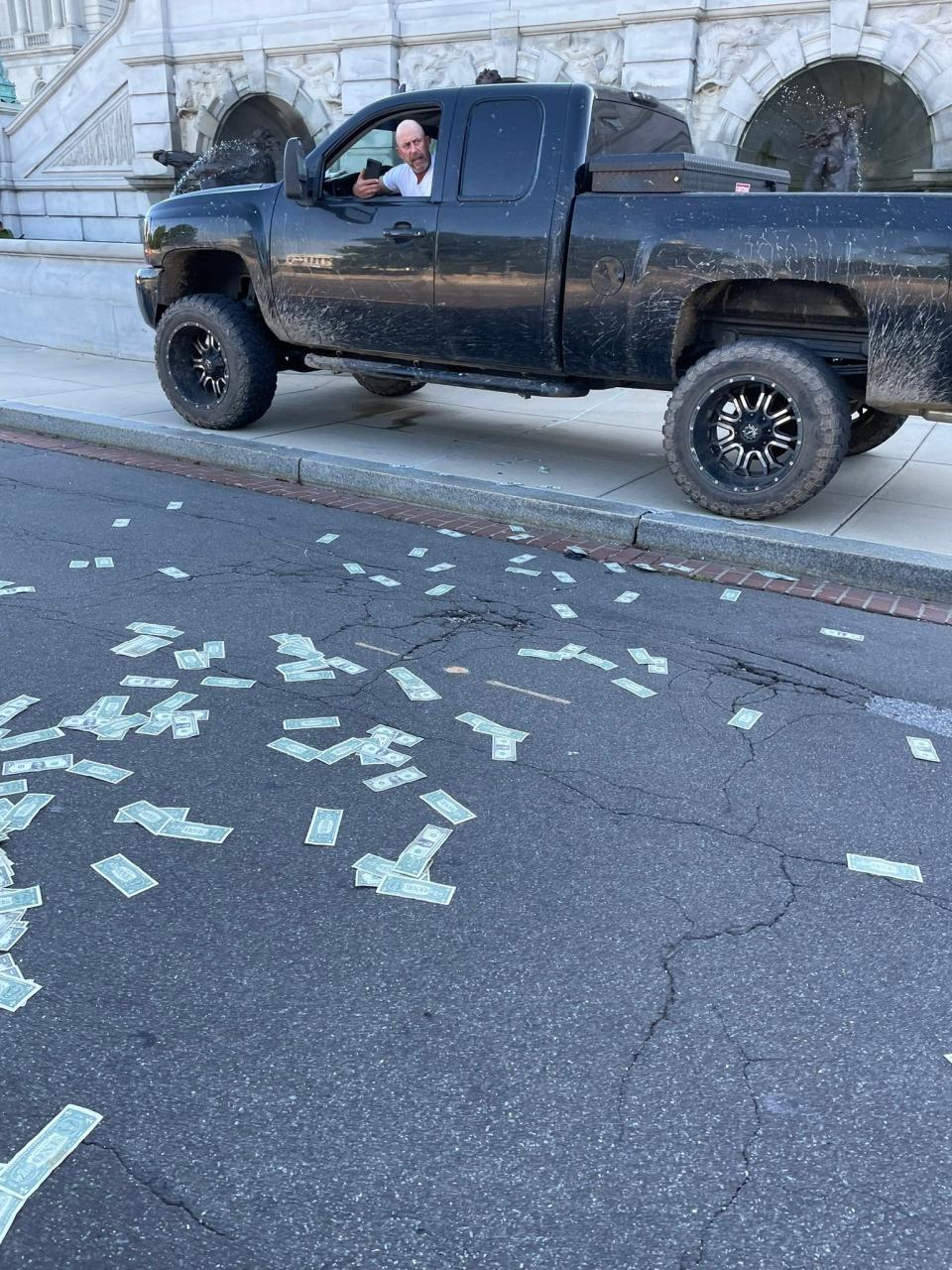 An eyewitness photo from near the Library of Congress shows the alleged suspect threatening the Capitol area with potential explosives. (Sydney Bobb)