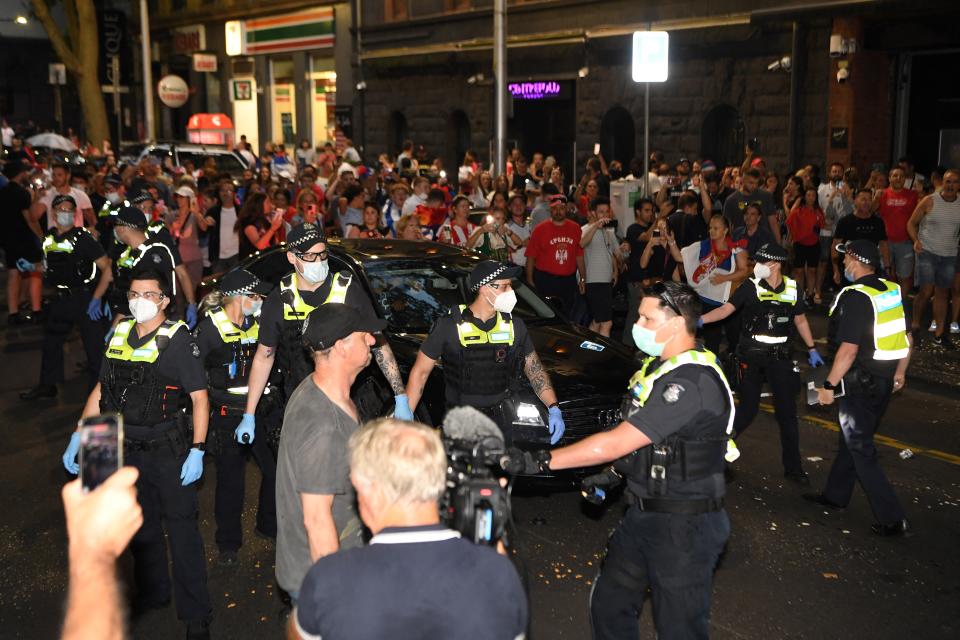 Seen here, police officers pepper spray Novak Djokovic supporters to clear a road for the tennis champion's car in Melbourne.