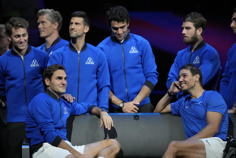 An emotional Roger Federer, left, of Team Europe sits alongside his playing partner Rafael Nadal after their Laver Cup doubles match against Team World's Jack Sock and Frances Tiafoe at the O2 arena in London, Friday, Sept. 23, 2022. Federer's losing doubles match with Nadal marked the end of an illustrious career that included 20 Grand Slam titles and a role as a statesman for tennis. (AP Photo/Kin Cheung)