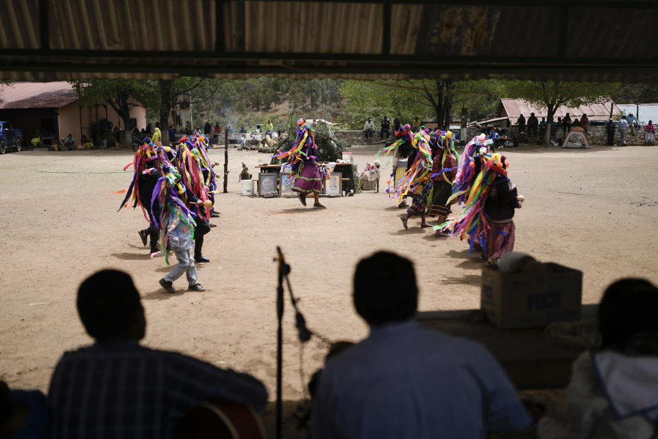 Raramuri Indigenous youth dance during a sacred Yumari ceremony to ask for rain and good crops and to honor two local Jesuit priests, Javier Campos and Joaquin Mora, who were murdered in 2022 by a gang leader, in Cuiteco, Mexico, Saturday, May 11, 2024. Among the inhabitants of the Tarahumara mountains, especially among the Indigenous Raramuri people, priests are often regarded as profoundly beloved figures who fearlessly offer comfort and help. (AP Photo/Eduardo Verdugo)