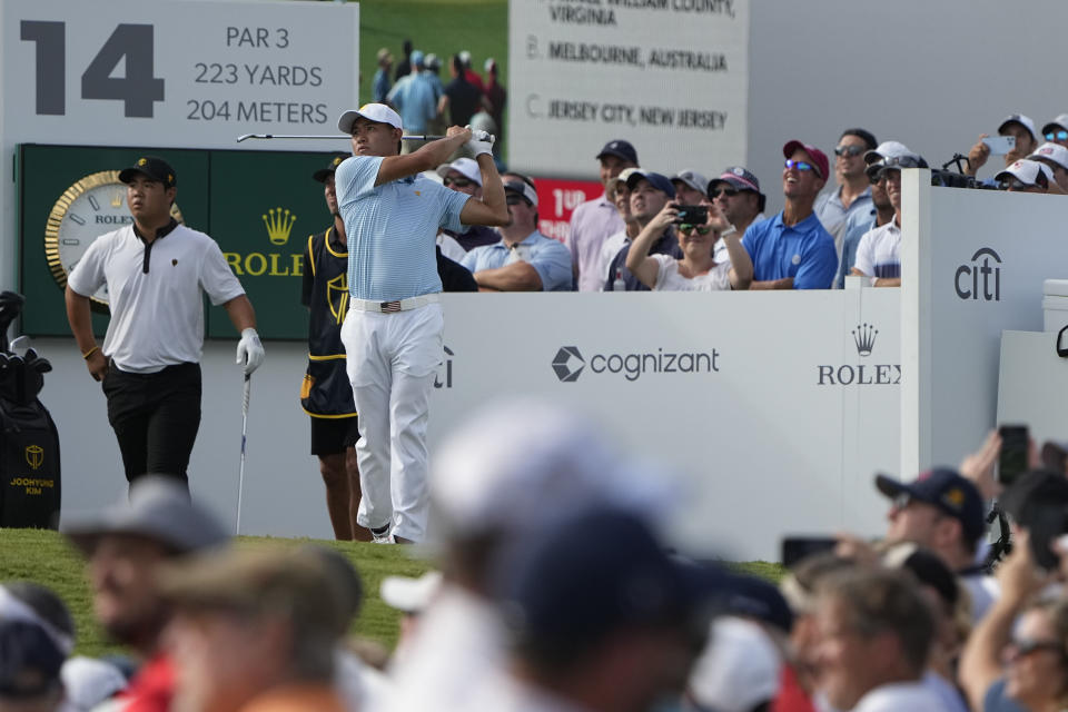 Collin Morikawa hits off the 14th tee during their foursomes match at the Presidents Cup golf tournament at the Quail Hollow Club, Thursday, Sept. 22, 2022, in Charlotte, N.C. (AP Photo/Chris Carlson)