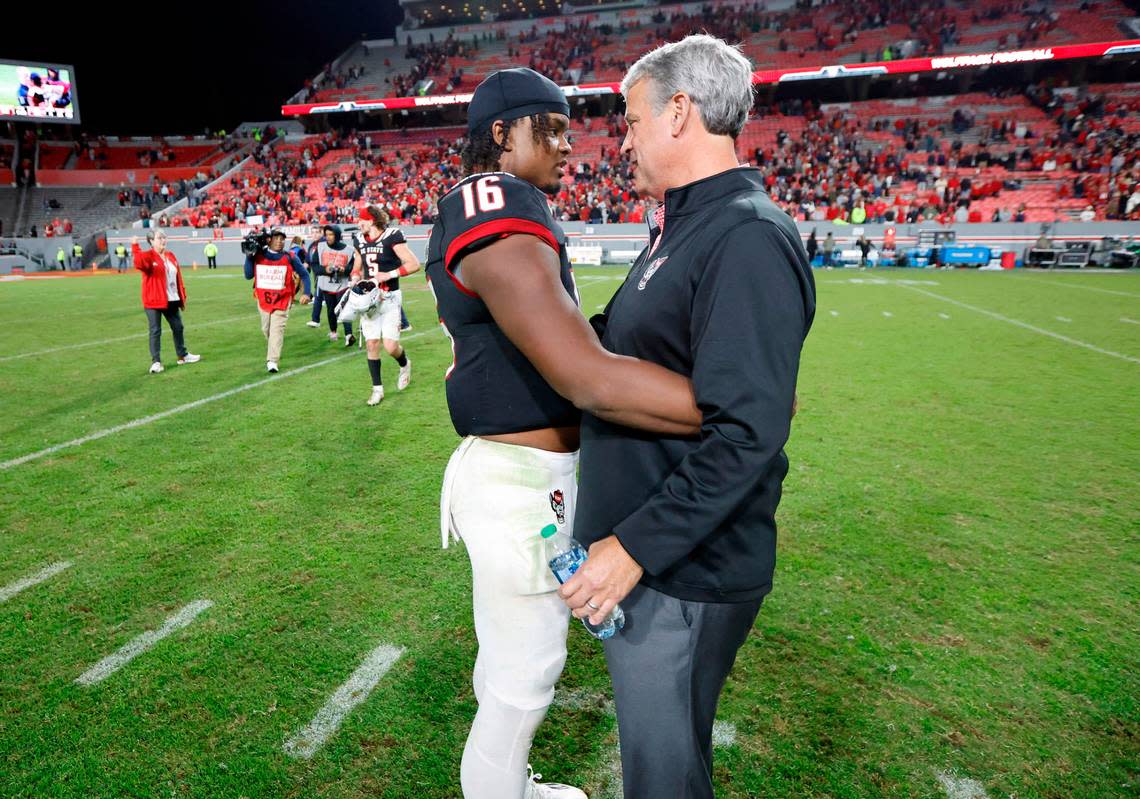 N.C. State athletics director Boo Corrigan talks with quarterback MJ Morris (16) after N.C. State’s 22-21 victory over Virginia Tech at Carter-Finley Stadium in Raleigh, N.C., Thursday, Oct. 27, 2022.