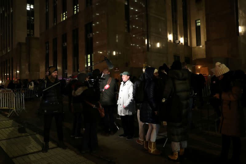 People wait outside court ahead of Film producer Harvey Weinstein's first day of sexual assault trial in New York