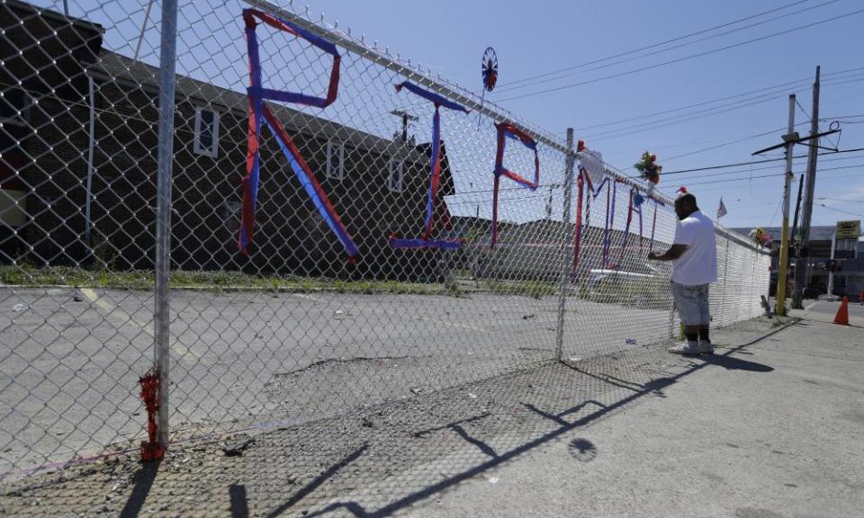 Dwayne Simmons makes a memorial to David McAtee near the intersection of 26th and Broadway in Louisville, Kentucky, on 2 June.