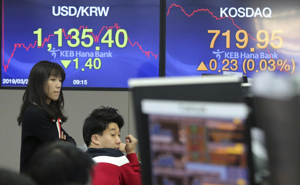 Currency traders watch monitors at the foreign exchange dealing room of the KEB Hana Bank headquarters in Seoul, South Korea, Friday, March 29, 2019. Asian markets were mostly higher on Friday as U.S. and Chinese officials kicked off a fresh round of trade talks in Beijing. (AP Photo/Ahn Young-joon)