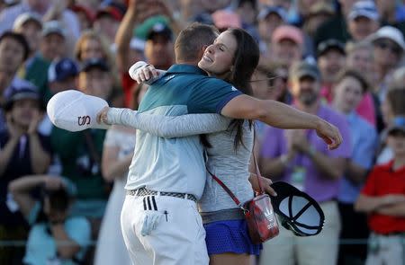 Sergio Garcia of Spain embraces his fiance Angela Akins after he won the 2017 Masters golf tournament in a playoff against Justin Rose of Englans at Augusta National Golf Club in Augusta, Georgia, U.S., April 9, 2017. REUTERS/Lucy Nicholson