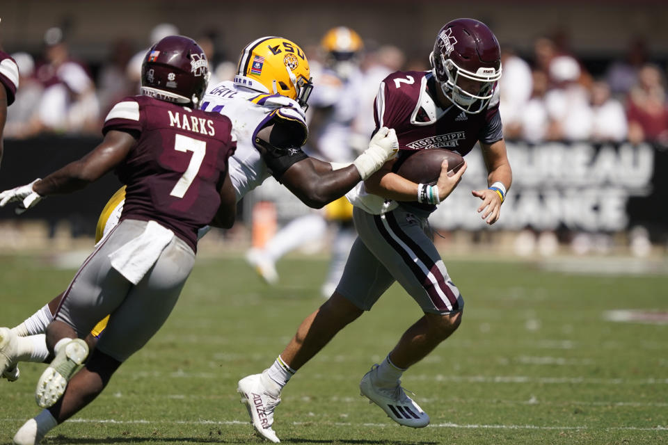 LSU defensive end Ali Gaye (11) pulls down Mississippi State quarterback Will Rogers (2) for a loss during the first half of an NCAA college football game, Saturday, Sept. 25, 2021, in Starkville, Miss. (AP Photo/Rogelio V. Solis)