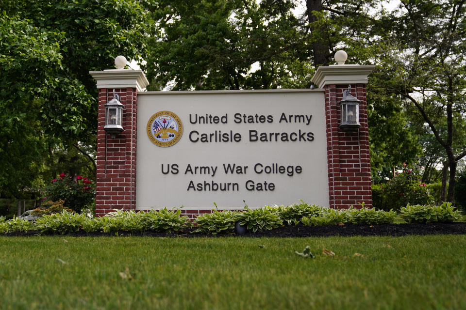 FILE - An entrance sign is seen outside the U.S. Army's Carlisle Barracks, Friday, June 10, 2022, in Carlisle, Pa. The remains of five more Native American children who died at a notorious government-run boarding school in Pennsylvania more than a century ago will be disinterred from a small Army cemetery and returned to descendants, authorities said. (AP Photo/Matt Slocum, File)