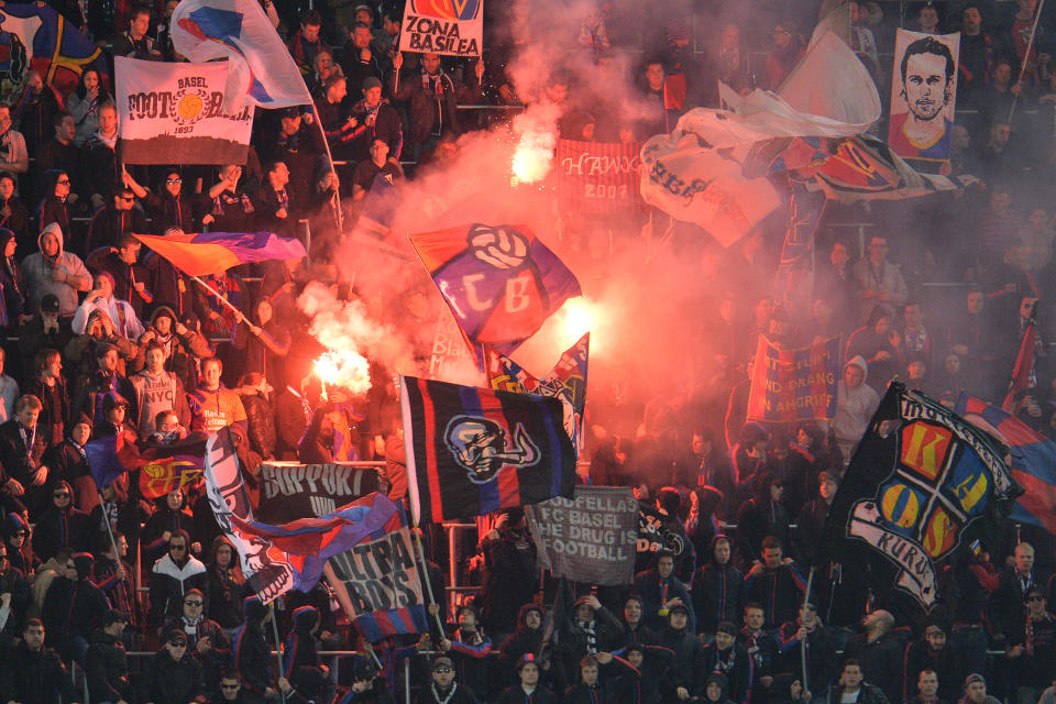 Basel's fans light fireworks during the Europa League round of 16 second leg soccer match between Red Bull Salzburg and FC Basel in Salzburg, Austria, on Thursday, March 20, 2014. (AP Photo/Kerstin Joensson)