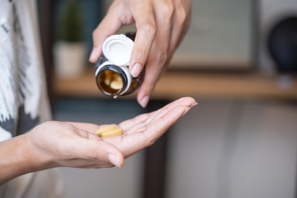 A woman taking supplements.