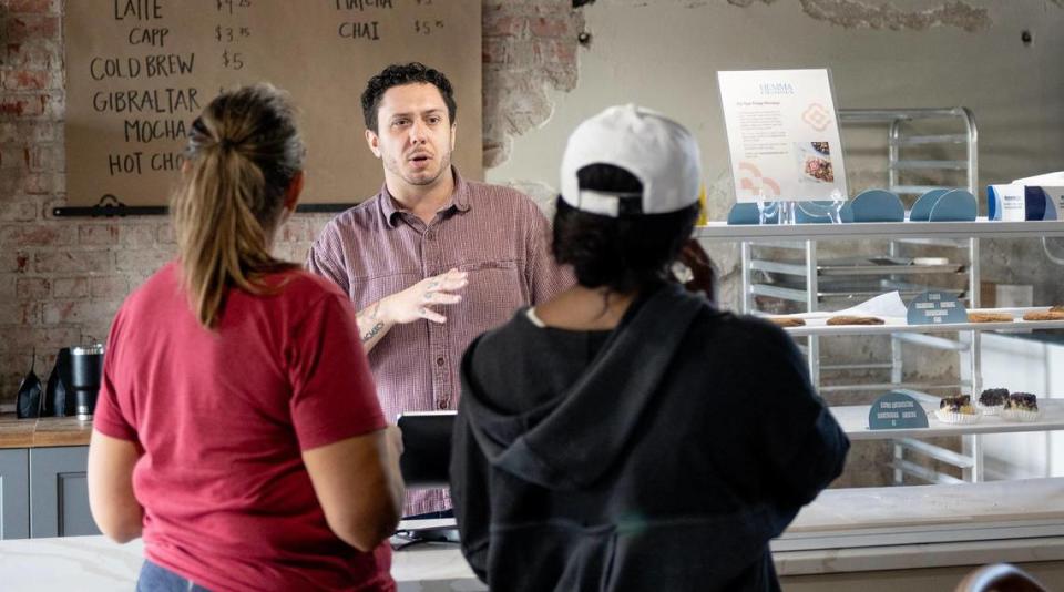 Lead barista Travis Strohmeyer serves customers at Hemma Hemma’s coffee bar.