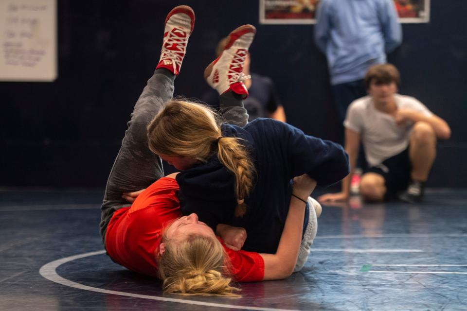 Keke Howell, bottom and Justice Lambert wrestling during practice at Reitz High School Thursday, Jan. 4, 2024.
