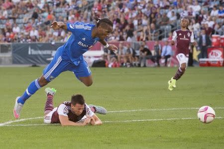 Oct 10, 2015; Commerce City, CO, USA; Montreal Impact forward Didier Drogba (11) leaps over a diving Colorado Rapids defender Sean St. Ledger (24) in the second half at Dick's Sporting Goods Park. The Impact defeated the Rapids 1-0. Mandatory Credit: Isaiah J. Downing-USA TODAY Sports