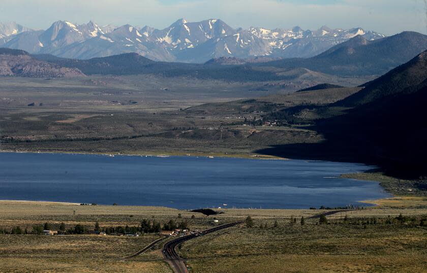 Mammoth Lakes, CA -The last vestiges of snow from last winter's record precipitation cling to the Sierra Nevada Mountains and serve as a backdrop to Mono Lake and Highway 395 on Thursday, July 27, 2023. After years of prolomged drought lakes and streams in the Sierra Nevada have been replenished by plenty of snowmelt. (Luis Sinco / Los Angeles Times)