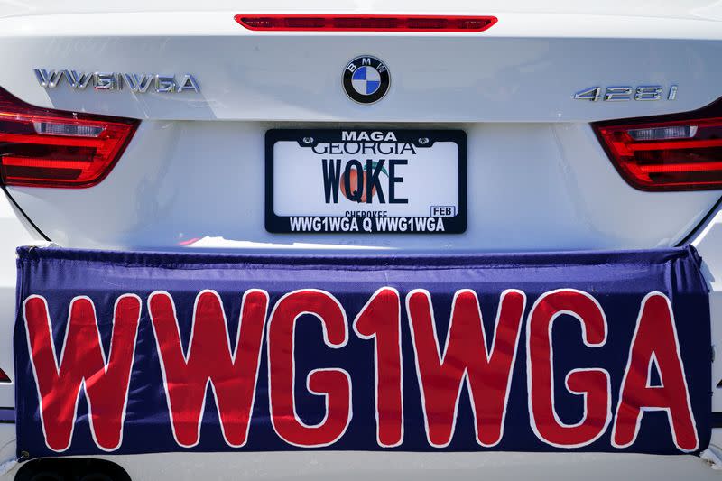 References to WWG1WGA, the QAnon slogan, are seen on a car that participated in a caravan convoy in Adairsville