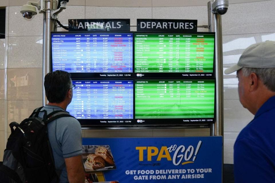 The arrival and departures board listed numerous flight cancelations at Tampa International Airport before the airport closed Tuesday, ahead of Hurricane Ian.