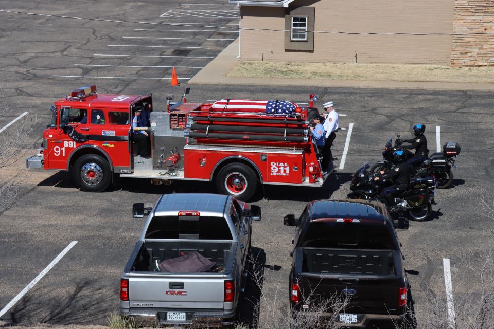 Fritch Volunteer Fire Chief Zeb Smith is placed on the top of a firetruck as he was transported to Westlawn Memorial Park just outside of Fritch on Saturday afternoon.