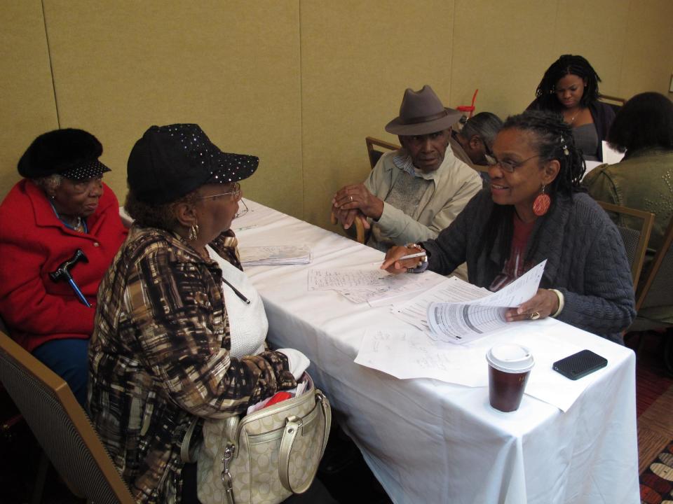 TO MOVE AT 3AM WEDNESDAY MARCH 28, 2012 -- In a Tuesday, Jan. 24, 2012 photo, lawyer Rose Sanders, right, helps a family fill out a claim application related to a settlement in a lawsuit between black farmers and the Agriculture Department in Memphis, Tenn. Black farmers had sued the department, claiming discrimination in USDA loan application from 1981 to 1996. (AP Photo/Adrian Sainz)