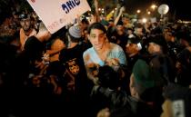 Protesters hold signs and shout slogans against the wedding of groom Mahmoud Mansour, 26, and bride Maral Malka, 23, outside a wedding hall in Rishon Lezion, near Tel Aviv August 17, 2014. Israeli police on Sunday blocked more than 200 far-right Israeli protesters from rushing guests at the wedding of a Jewish woman and Muslim man as they shouted "death to the Arabs" in a sign of tensions stoked by the Gaza war. Picture taken August 17, 2014. To match MIDEAST-ISRAEL/WEDDING REUTERS/Ammar Awad