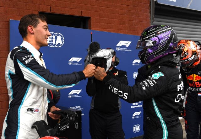 George Russell (left) fist-bumps Lewis Hamilton