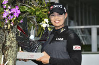 Ariya Jutanugarn of Thailand poses with her trophy for photographers during the award ceremony after winning the LPGA Honda Thailand golf tournament in Pattaya, southern Thailand, Sunday, May 9, 2021. (AP Photo/Kittinun Rodsupan)