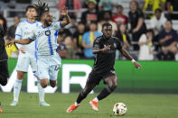 Nashville SC midfielder Dru Yearwood, right, moves the ball past CF Montréal forward Raheem Edwards (44) during the first half of an MLS playoff soccer match Saturday, May 4, 2024, in Nashville, Tenn. (AP Photo/George Walker IV)
