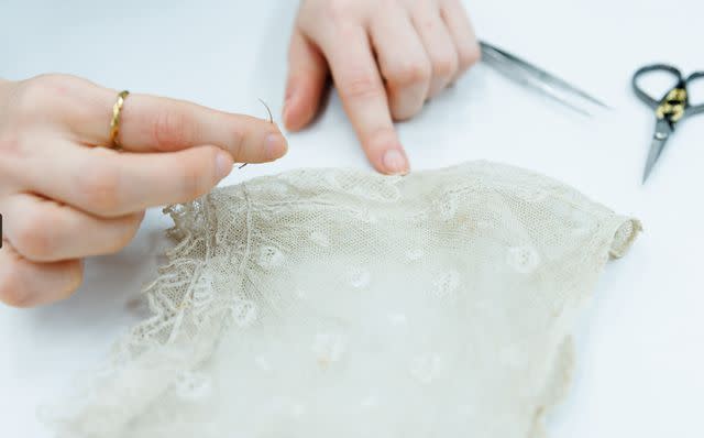 <p>Historic Royal Palaces</p> A detail of Queen Charlotte’s dress displayed at the new exhibit “Untold Lives: A Palace at Work” at Kensington Palace.