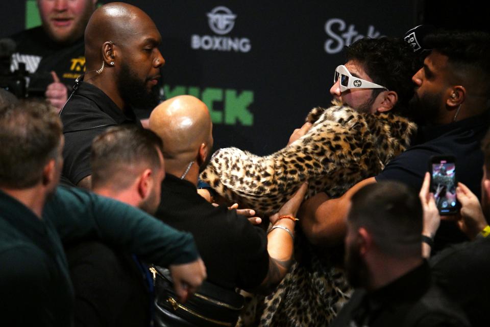 Dillon Danis is held back after clashing with Logan Paul (not pictured) during a KSI v Tommy Fury Prime Card press conference in Manchester, England.