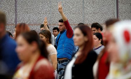 Kurdish people observe a moment of silence for activists who were killed in a suicide bombing in Ankara, during a political rally in Tokyo October 15, 2015. To match Special Report JAPAN-KURDS/ REUTERS/Toru Hanai