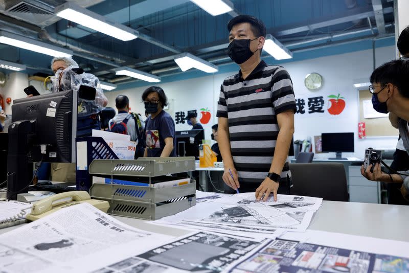 FILE PHOTO: Staff members of Apple Daily work on their final edition in Hong Kong